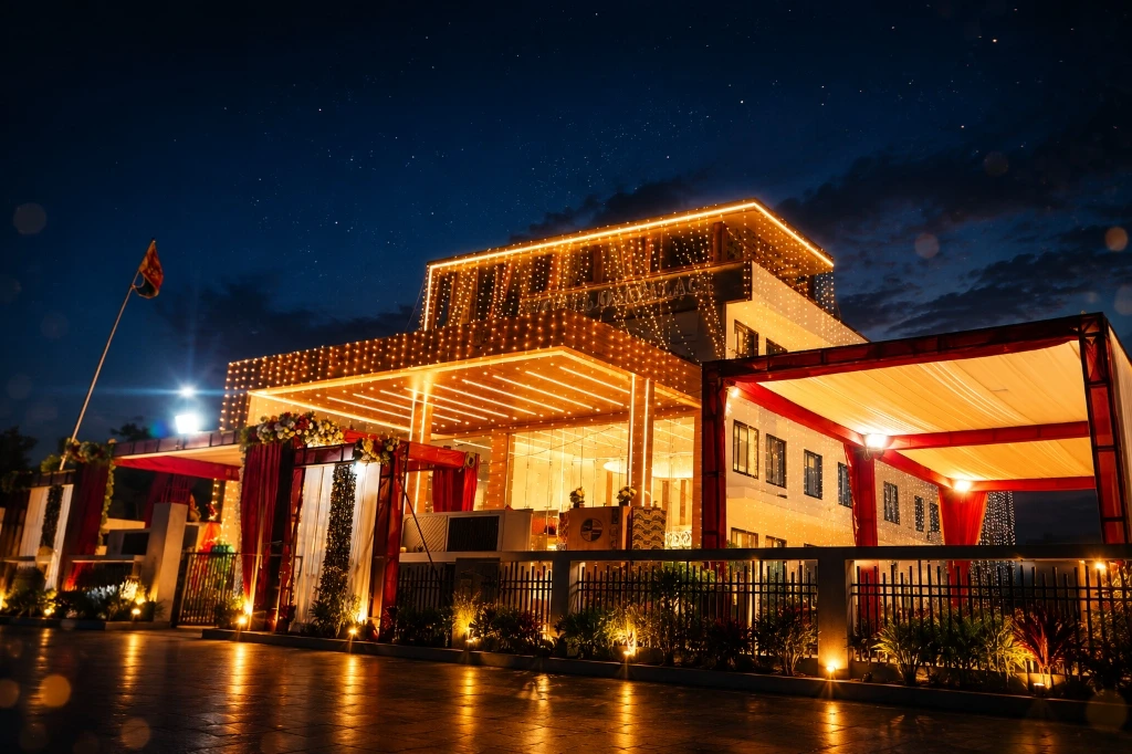 HOTEL OM PALACE — Night exterior with festive fairy lights and starry sky